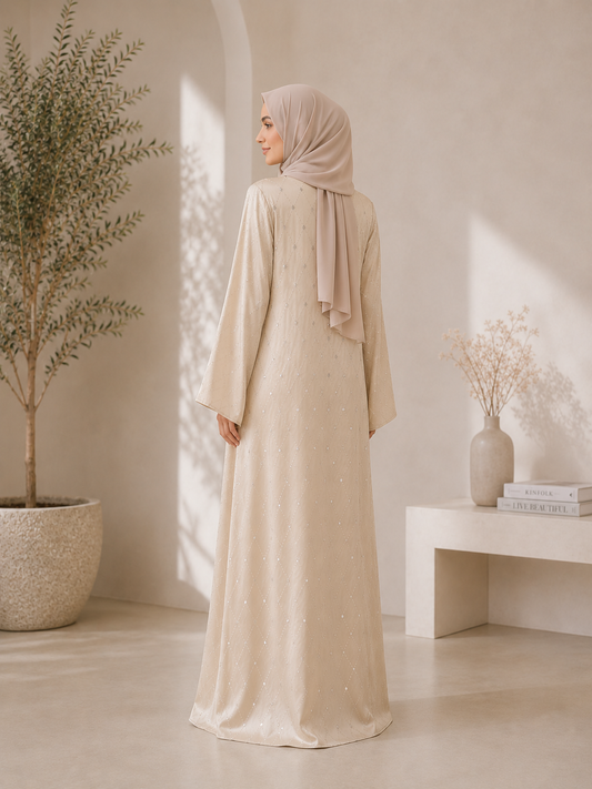 Champagne closed abaya with V-neck, small whites stones across abaya and adorned with raised stones that added texture and sparkles