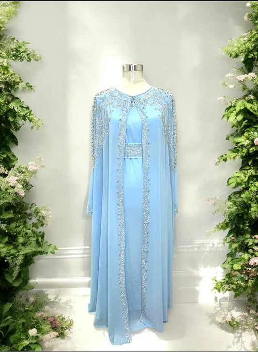 A baby blue abaya designed with a flowing cape, delicately adorned with shimmering stone embellishments for a graceful and sophisticated finish.