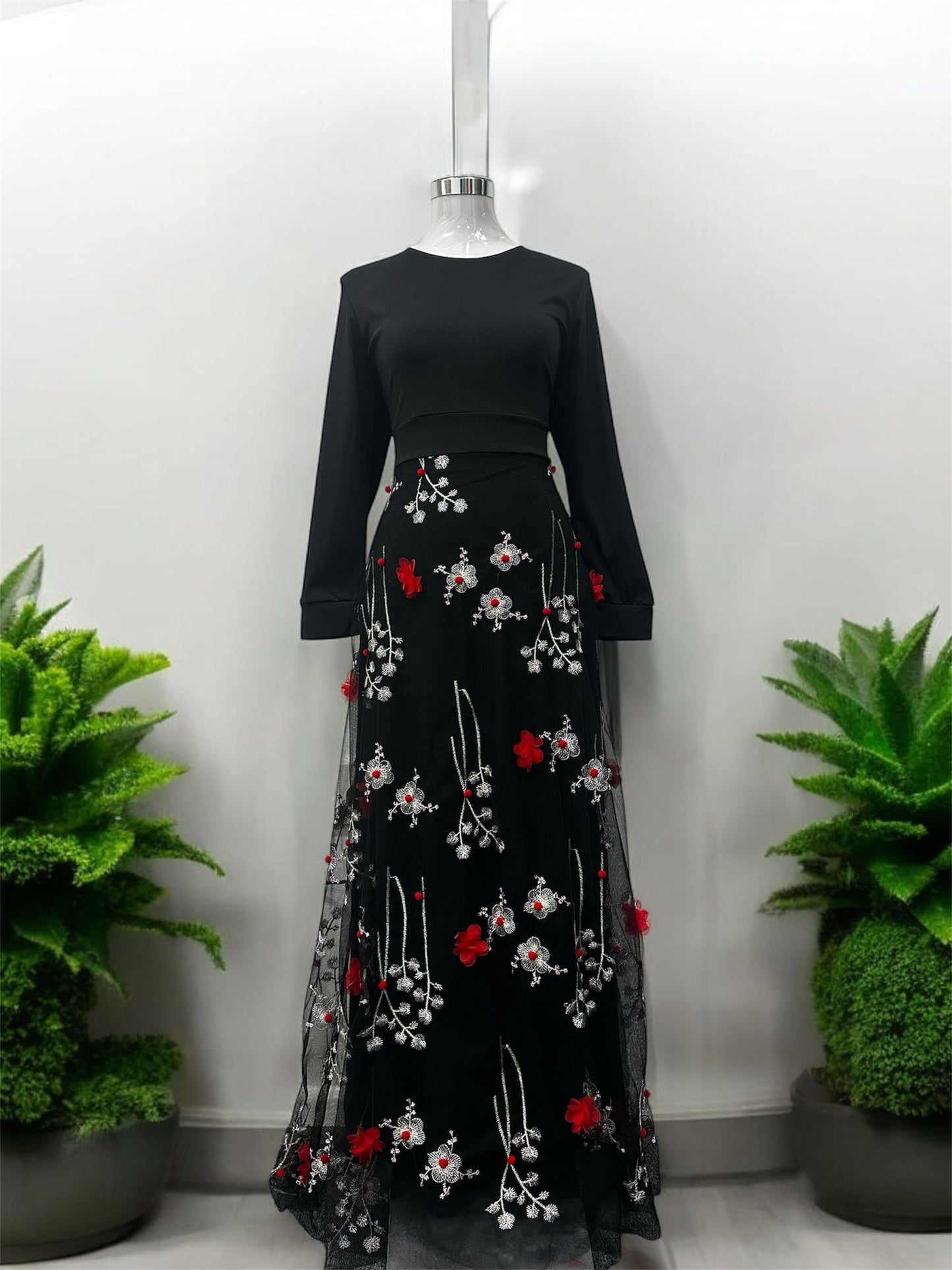 DD - Design dress,
Applique design,
Black with white
flowers embroidered
and red flower as
applique and
invisible zip at the
back