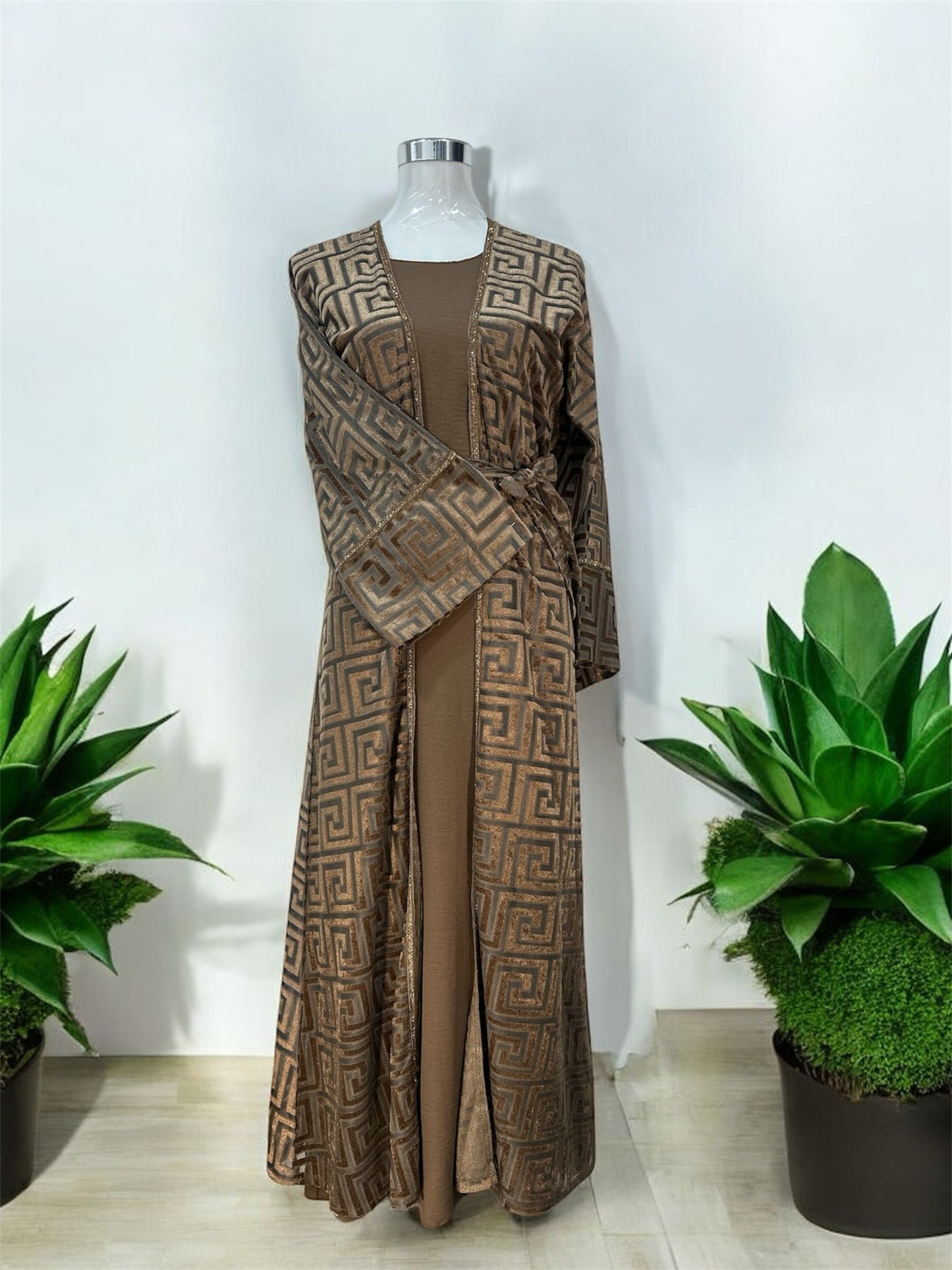 Our Mahaba Abaya -&nbsp; featuring a graceful inner dress paired with a statement outer overcoat. The overcoat showcases a modern geometric pattern that adds a refined, contemporary touch, while its relaxed silhouette ensures effortless comfort.