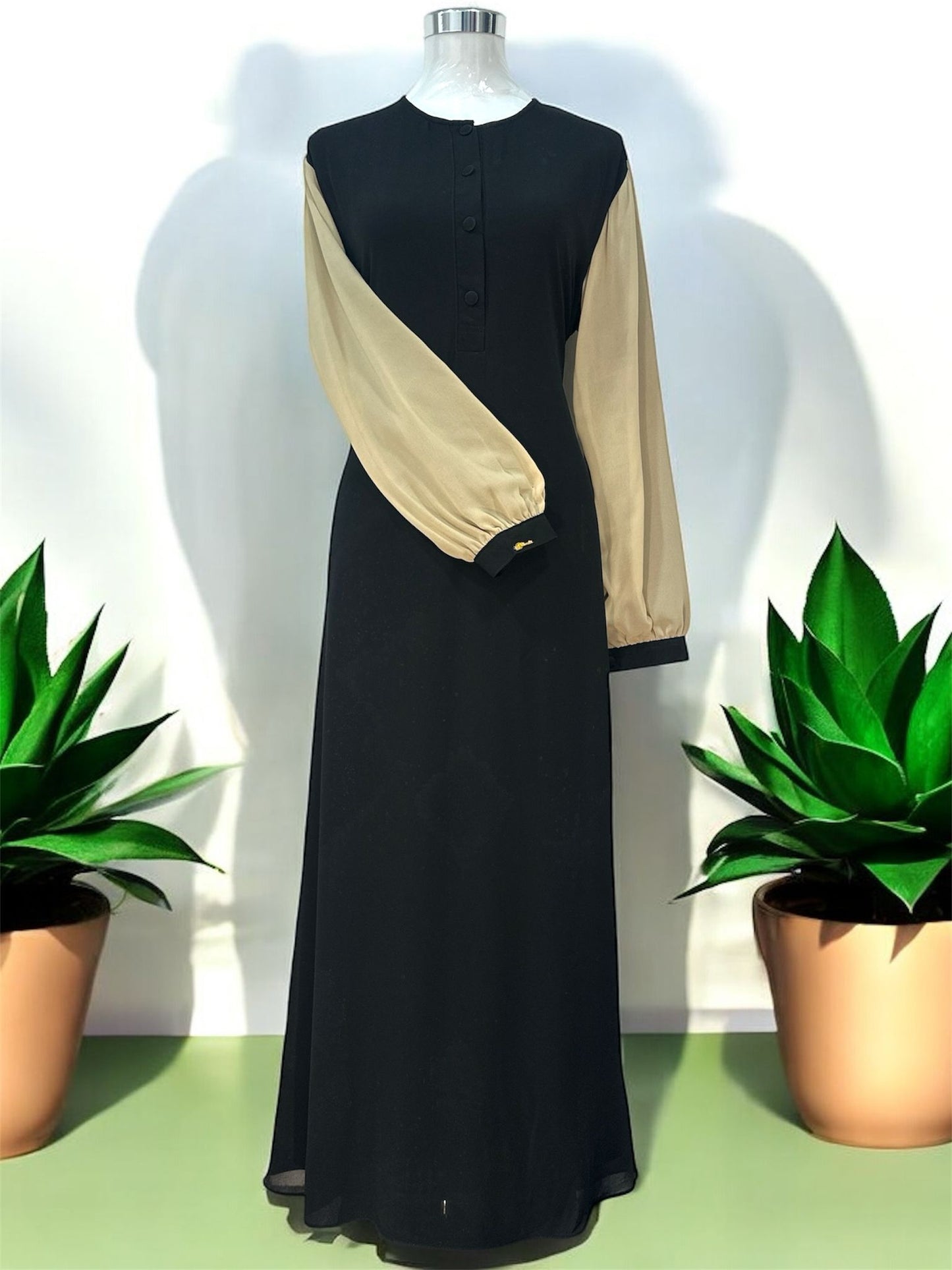 Champagne Ulfah jubah features contrast sleeve accents, a polished front button placket, and structured banded cuffs for a contemporary finish.