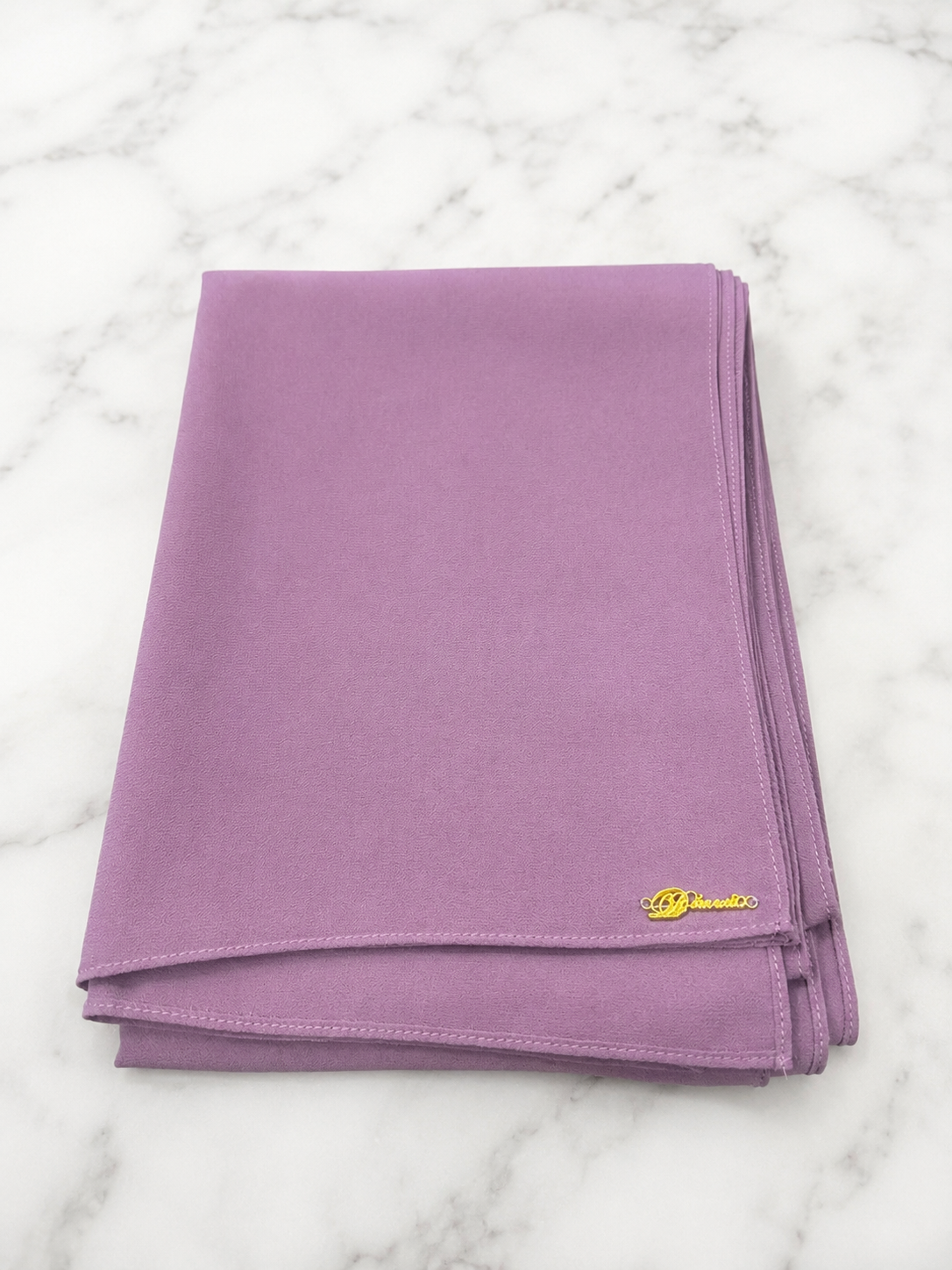 Graceful chiffon shawls with a soft, flowy drape. Light and airy, perfect for everyday wear or special occasions, finished with a subtle logo for a touch of understated elegance.
