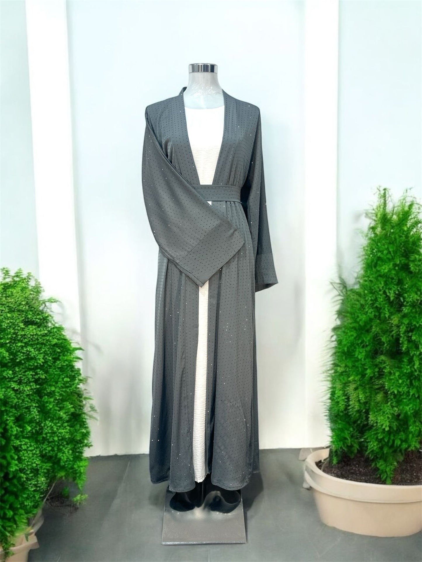Grey Lamura Abaya was designed in an overcoat style, featuring delicate blue stone embellishments across the overcoat for sophisticated looks and short sleeve innerwear providing comfort. Comes complete with a coordinating cloth belt and matching shawl.