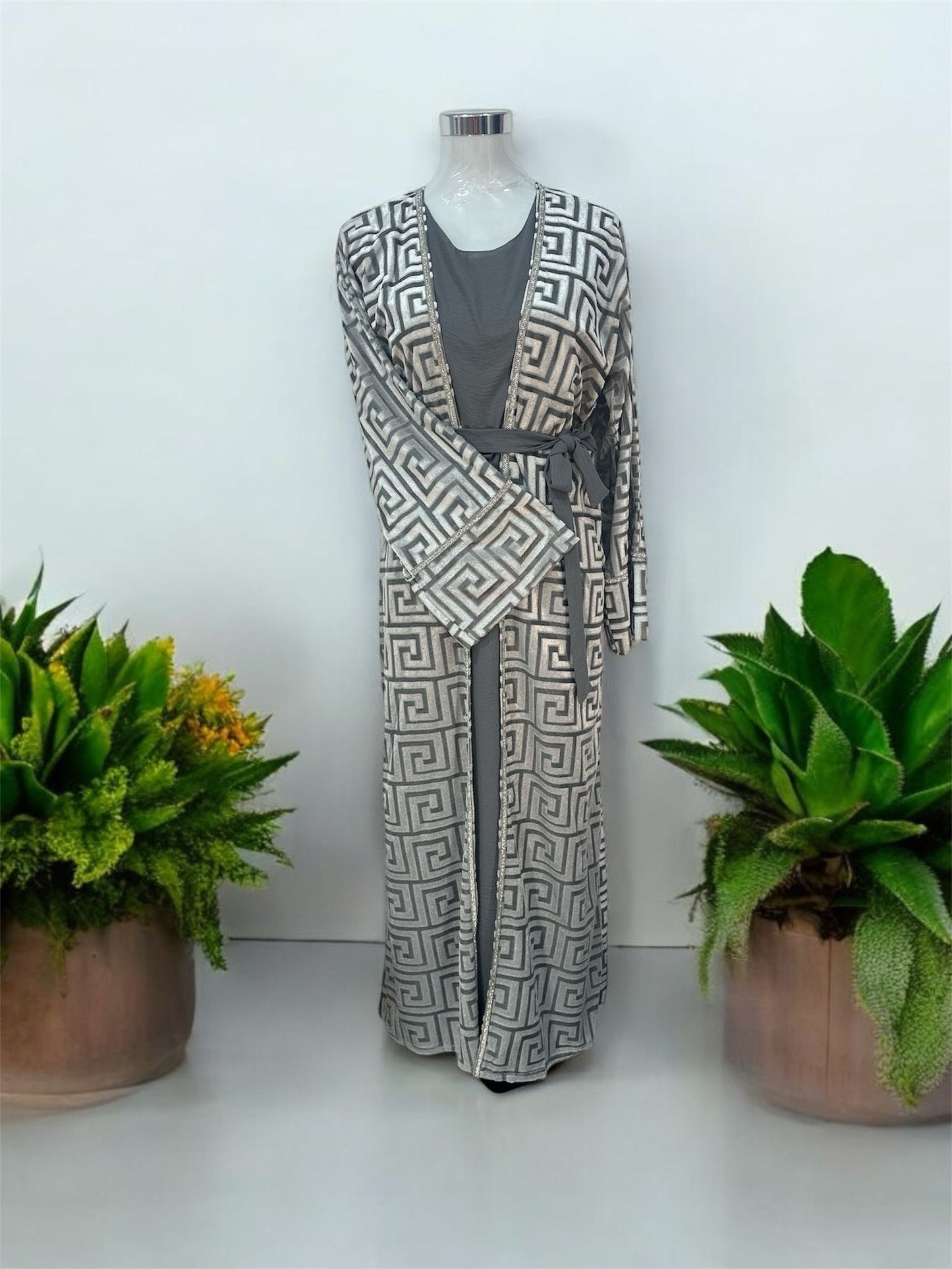 Our Mahaba Abaya -&nbsp; featuring a graceful inner dress paired with a statement outer overcoat. The overcoat showcases a modern geometric pattern that adds a refined, contemporary touch, while its relaxed silhouette ensures effortless comfort.