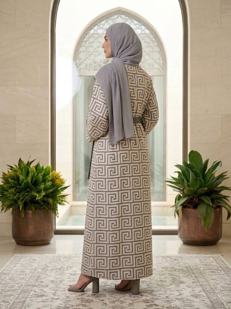Our Mahaba Abaya -&nbsp; featuring a graceful inner dress paired with a statement outer overcoat. The overcoat showcases a modern geometric pattern that adds a refined, contemporary touch, while its relaxed silhouette ensures effortless comfort.