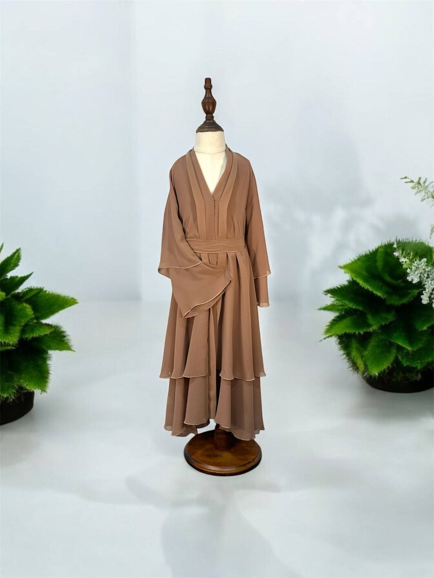 Elevate your modest wardrobe with this exquisitely crafted, multi-tiered chiffon abaya set. Designed with a contemporary silhouette, this piece features flowing layered details and dramatic bell sleeves that bring graceful movement to every step. Perfectly balancing sophistication and modesty, it is an ideal choice for special occasions, formal gatherings, or elegant evening wear.