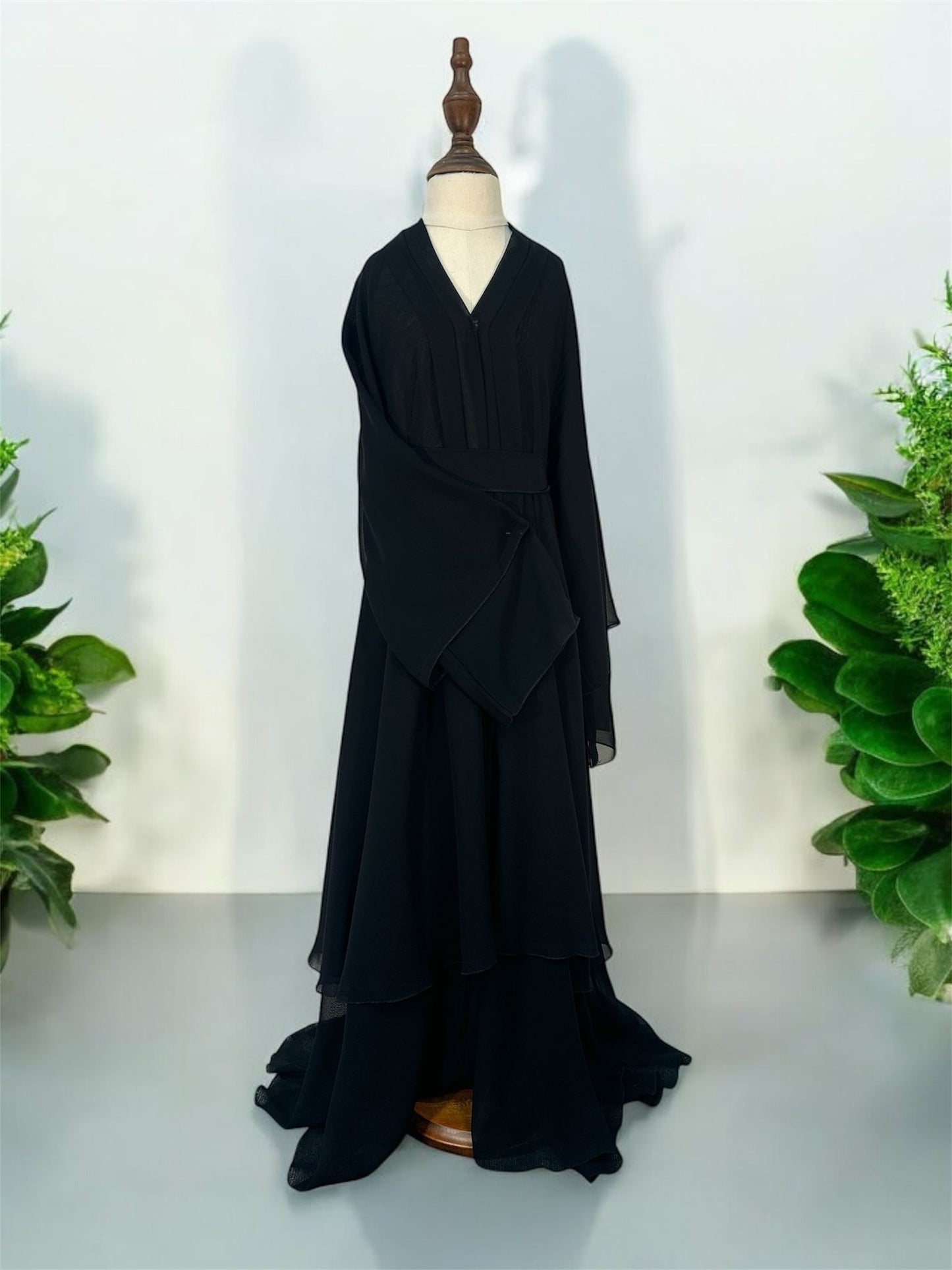 Elevate your modest wardrobe with this exquisitely crafted, multi-tiered chiffon abaya set. Designed with a contemporary silhouette, this piece features flowing layered details and dramatic bell sleeves that bring graceful movement to every step. Perfectly balancing sophistication and modesty, it is an ideal choice for special occasions, formal gatherings, or elegant evening wear.