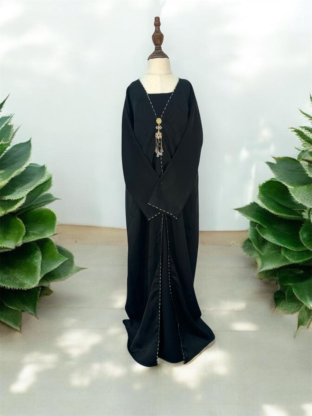 A sophisticated open-front abaya designed with understated elegance and modern refinement. Designed with wide relaxed sleeves and a loose flowing cut, this abaya offers both comfort and effortless style, making it perfect for layering over inner dresses or casual ensembles. Crafted from smooth, lightweight fabric, this piece features a subtle floral-textured pattern that adds depth and luxury to its timeless silhouette.