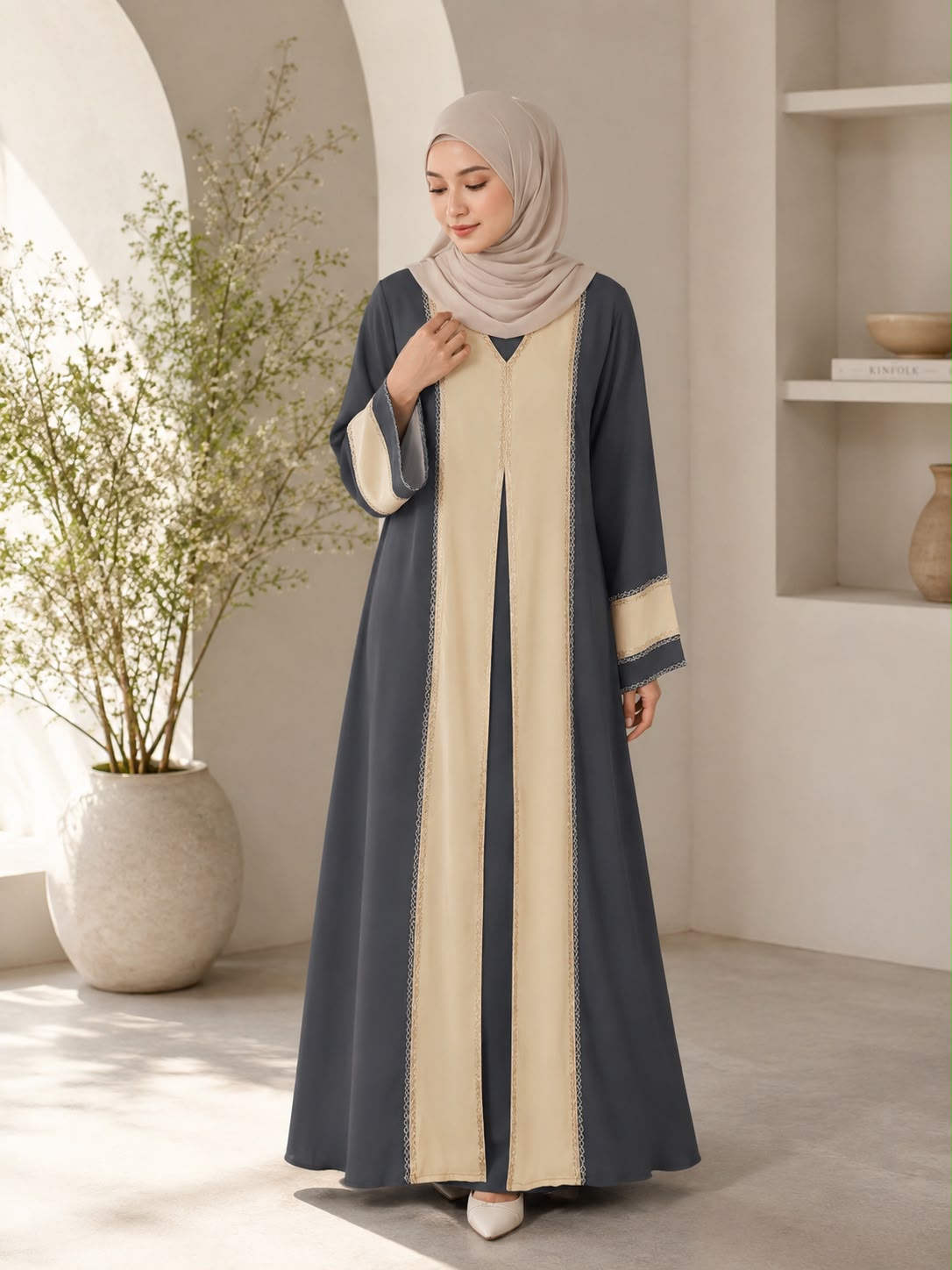 Elegant two-tone charcoal grey and beige colour combination
Flowing, modest and comfortable silhouette
Contrasting beige front panels for a refined layered effect
Delicate decorative trim detailing along the front panels
Wide flared sleeves with matching beige contrast accents
Beautifully designed for a graceful and feminine appearance
Versatile design suitable for both everyday and occasion wear
Easy to style with your favourite hijab and accessories