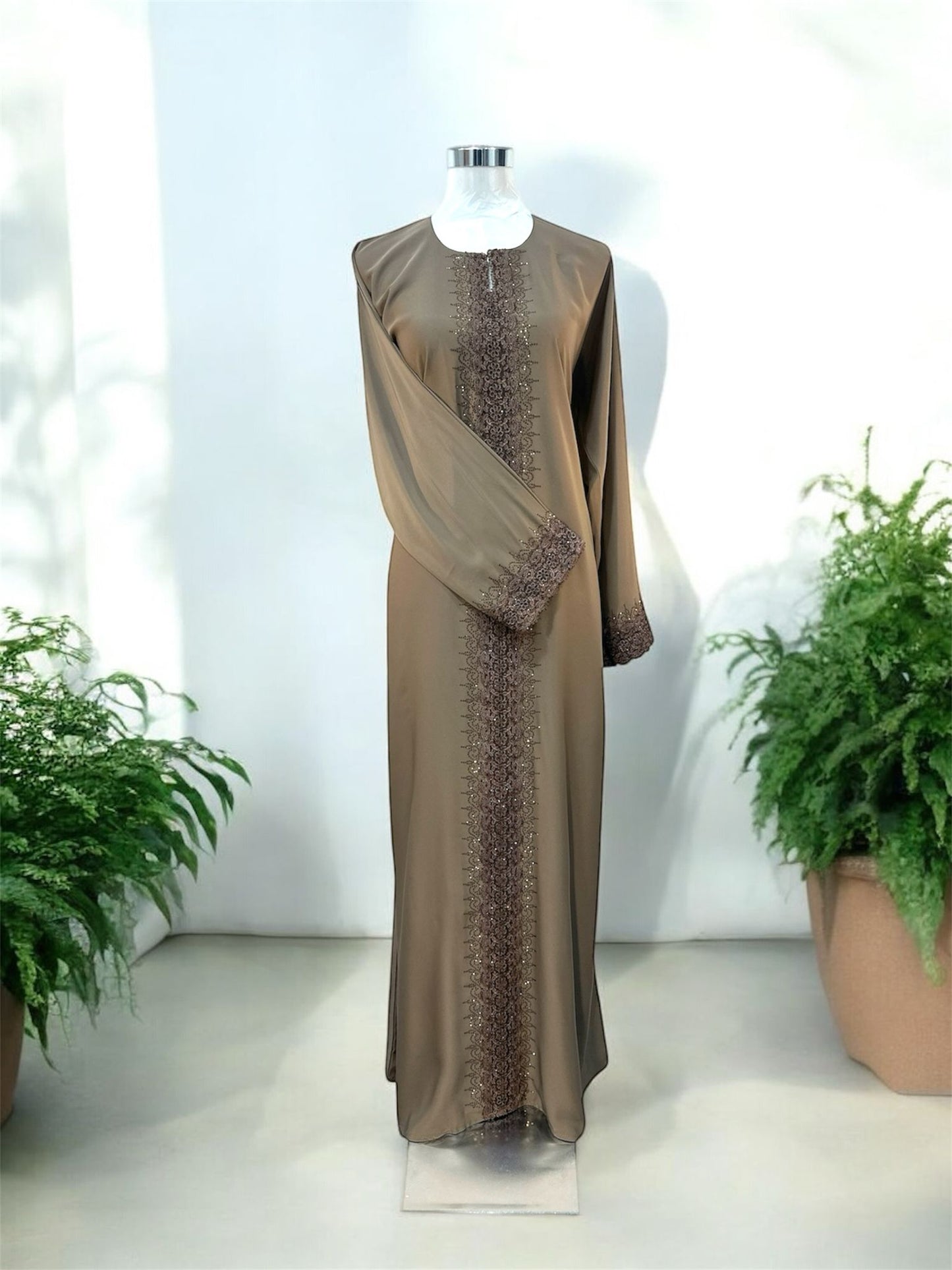 Brown Rana Jubah - with snap button, bottom sleeve and front abaya embroided and embellish
with dark brown tiny stones and comes with shawl





