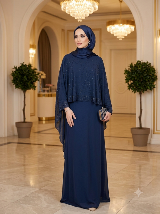 A navy jubah with a sew in flowing cape, featuring delicate bead embroidery across the cape for a graceful, understated elegance. Comes complete with a matching shawl.