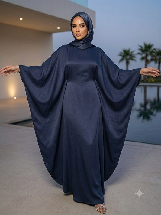 Elevate your wardrobe with this Najma kaftan, designed to perfectly balance contemporary style with timeless modesty. Crafted from premium fabric with a refined, low-sheen finish. The signature butterfly cut features fluid batwing sleeves that create a dramatic, sweeping drape, while the high neckline and full-length coverage ensure a sophisticated, minimalist silhouette.