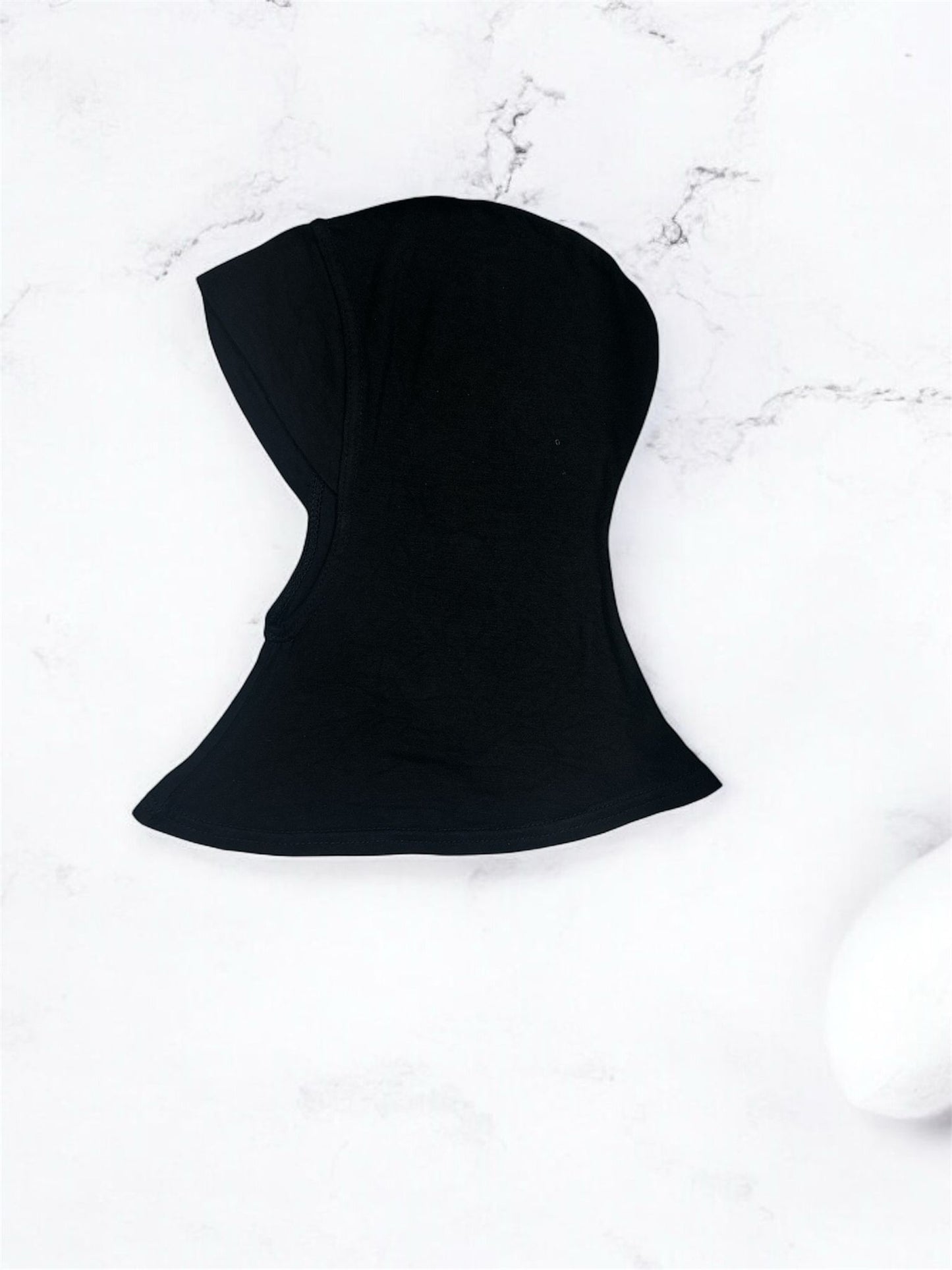 A short inner shawl designed with a chinless cut for a smooth, seamless fit under any hijab style. Crafted for comfort and ease, it sits neatly without bulk, ensuring a clean silhouette throughout the day. Perfect for effortless layering and all-day wear, it provides reliable coverage while maintaining a lightweight, breathable feel.
