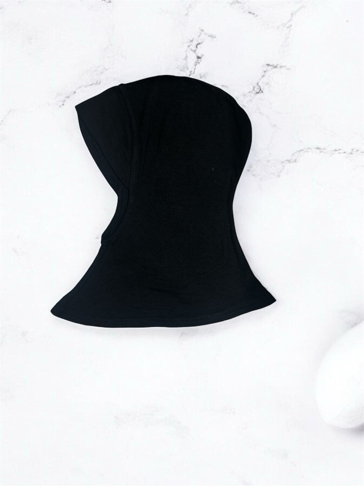 A short inner shawl designed with a chinless cut for a smooth, seamless fit under any hijab style. Crafted for comfort and ease, it sits neatly without bulk, ensuring a clean silhouette throughout the day. Perfect for effortless layering and all-day wear, it provides reliable coverage while maintaining a lightweight, breathable feel.