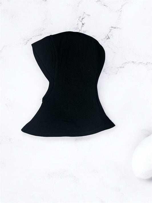 A short inner shawl designed with a chinless cut for a smooth, seamless fit under any hijab style. Crafted for comfort and ease, it sits neatly without bulk, ensuring a clean silhouette throughout the day. Perfect for effortless layering and all-day wear, it provides reliable coverage while maintaining a lightweight, breathable feel.