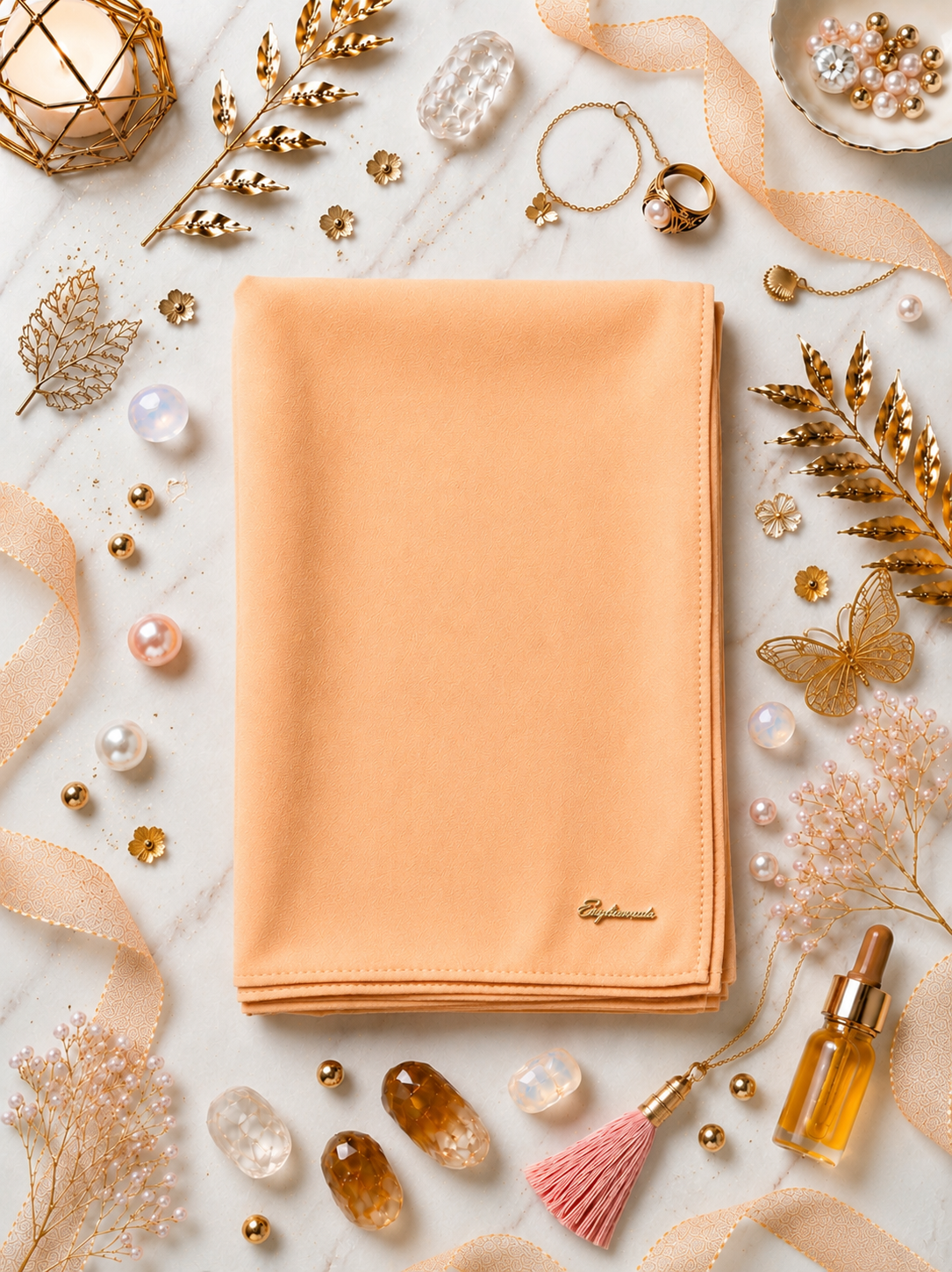 Baby Orange Graceful chiffon shawls with a soft, flowy drape. Light and airy, perfect for everyday wear or special occasions, finished with a subtle logo for a touch of understated elegance.