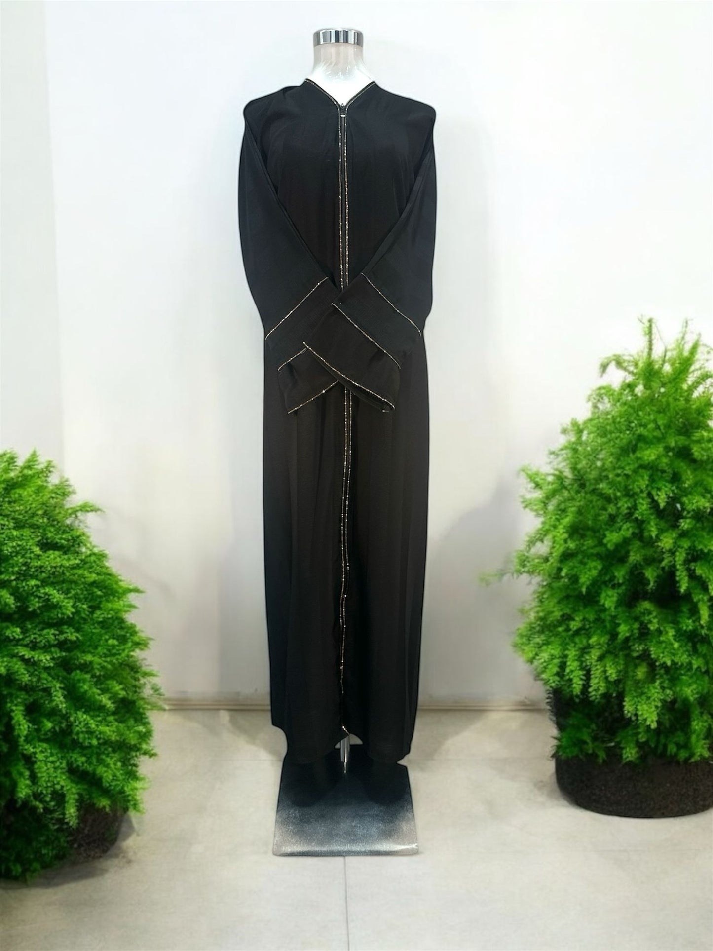 Our Nadra Abaya features sleek front opening with a central zip closure, framed by fine gold accents that elongate the figure and create a polished finish, subtly textured fabric enhances its overall elegance and comes with a shawl.