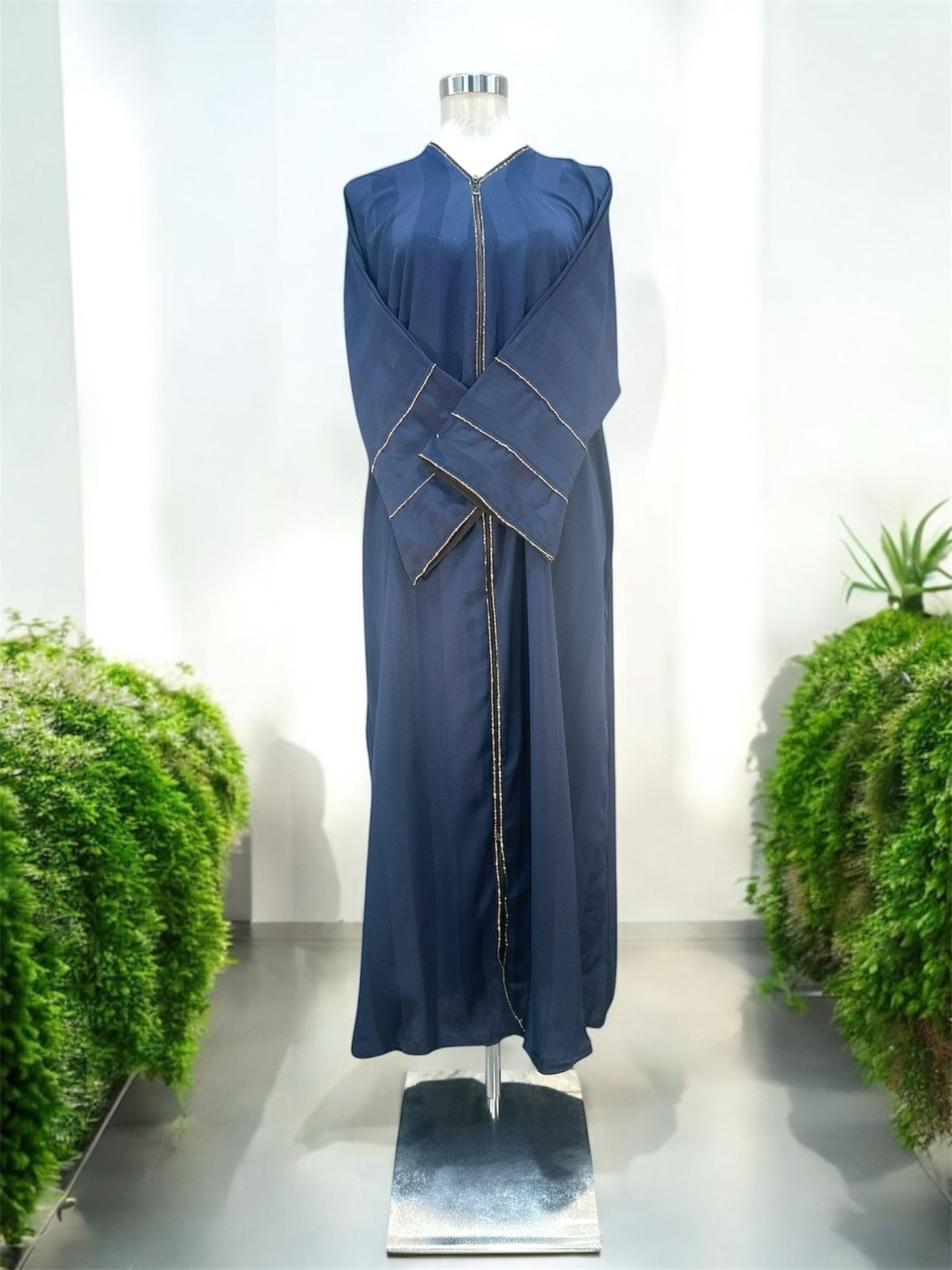 Our Nadra Abaya features sleek front opening with a central zip closure, framed by fine gold accents that elongate the figure and create a polished finish, subtly textured fabric enhances its overall elegance and comes with a shawl.