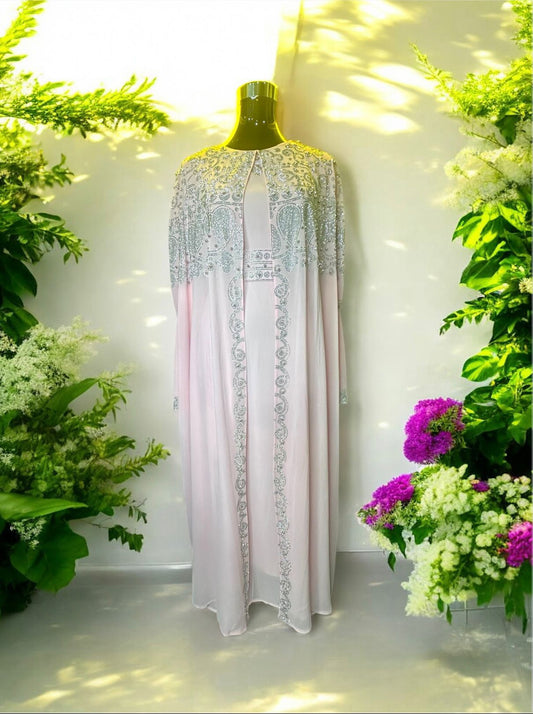 A Pink abaya designed with a flowing cape, delicately adorned with shimmering stone embellishments for a graceful and sophisticated finish.


